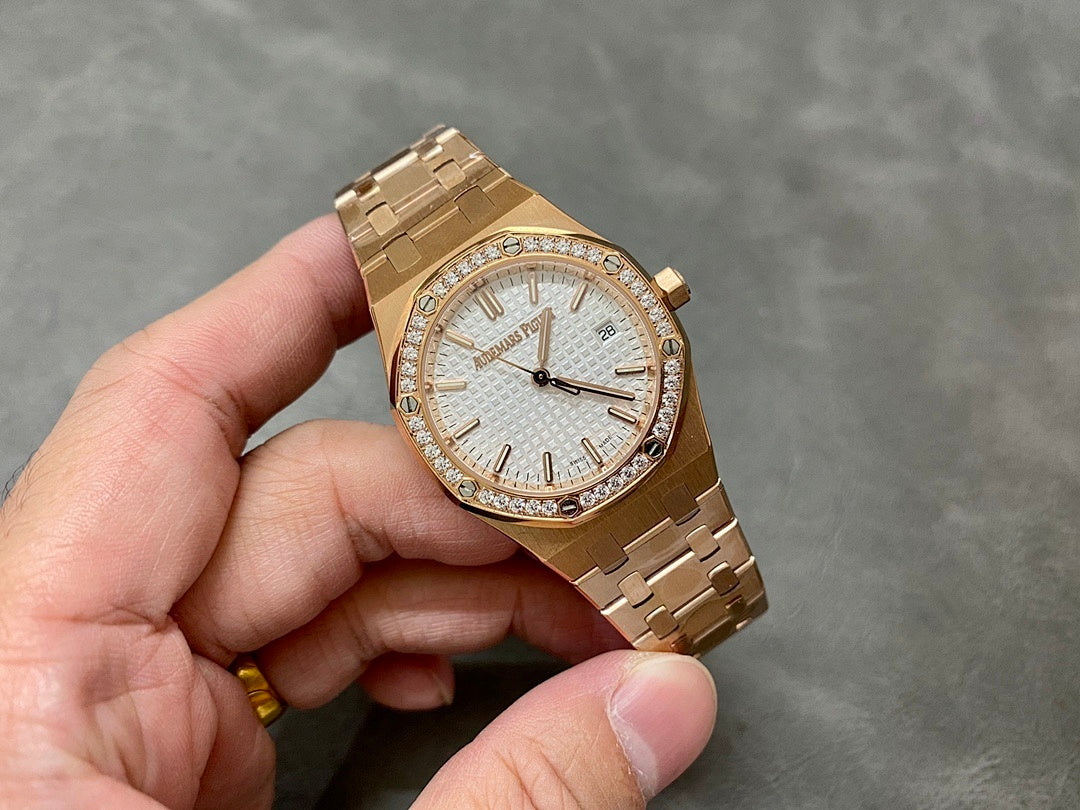 Rose gold watch with diamond bezel, white dial, and textured hour markers on bracelet