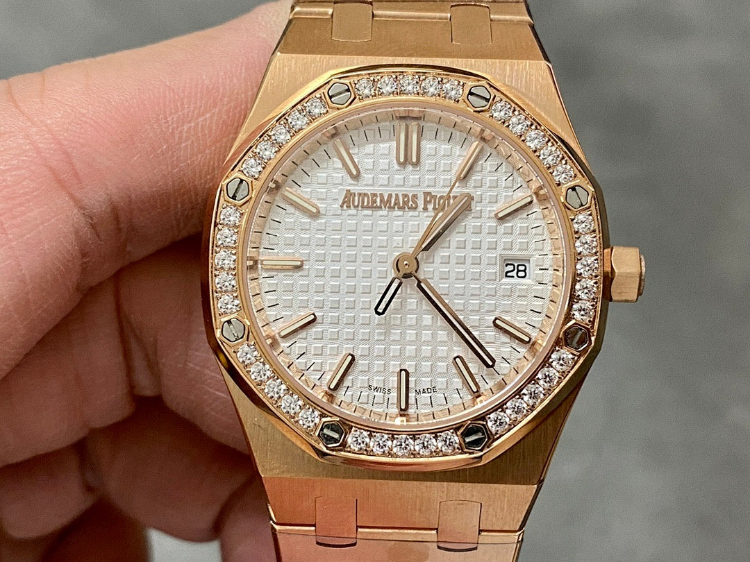 Rose gold Audemars Piguet watch with diamond bezel, white dial, and steel bracelet