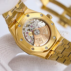 Gold-tone wristwatch showing open caseback with exposed mechanical movement