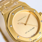Gold-tone wristwatch close-up of round dial with hands and bezel studs