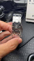 Audemars Piguet stainless steel watch back with bracelet and crown side view