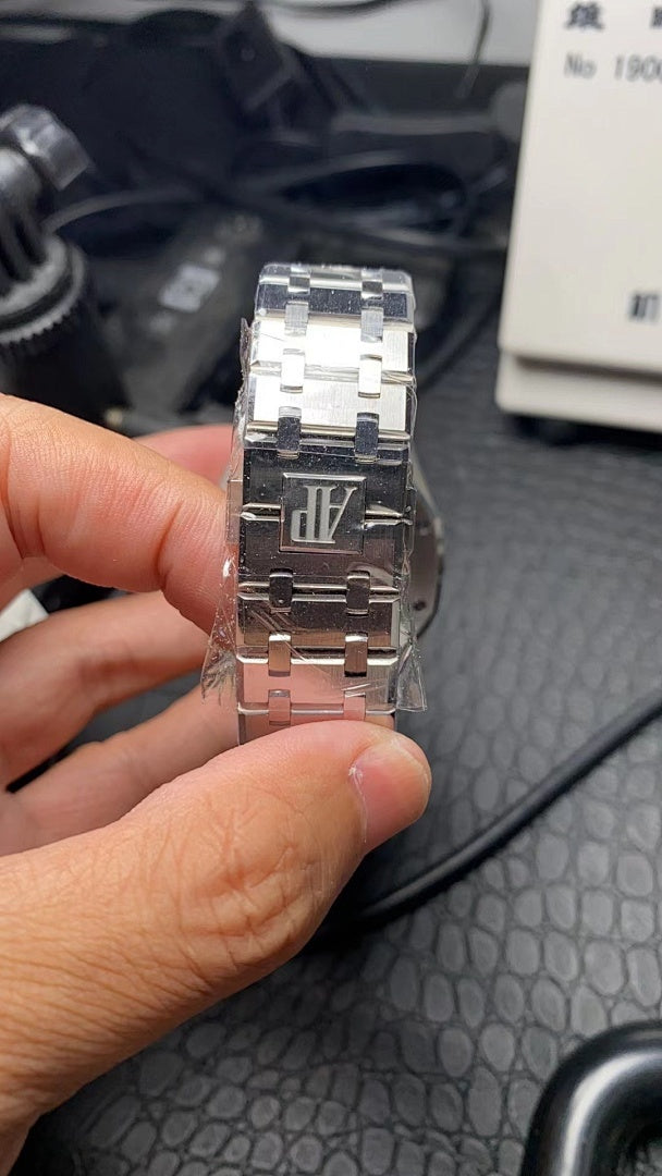 Audemars Piguet stainless steel watch back with bracelet and crown side view
