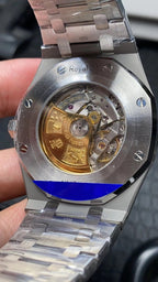 Audemars Piguet watch caseback with visible mechanical movement under glass