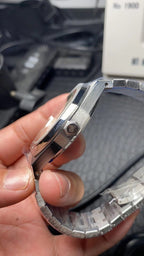Audemars Piguet watch side profile with crown and metal bracelet links