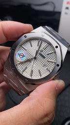 Audemars Piguet stainless steel watch with white textured dial and blue accent