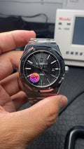 Audemars Piguet watch front view with dark dial and metal bracelet, date window at 21.