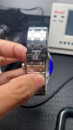 Audemars Piguet watch bracelet with clasp detail, dark links and silver-toned edges.