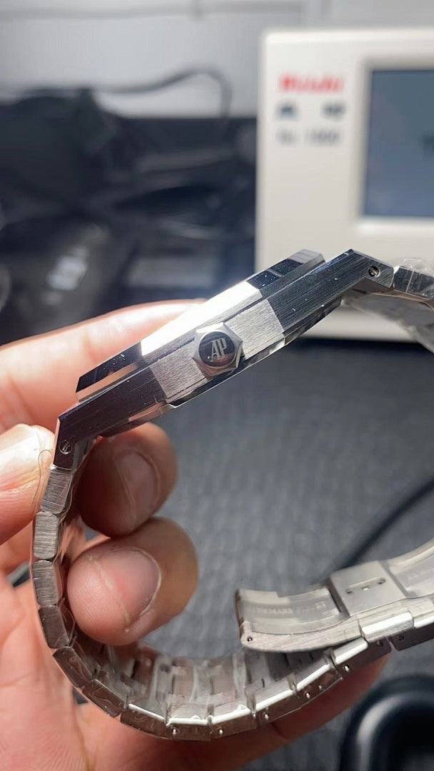 Audemars Piguet watch side profile with metal bracelet links and crown-side details.