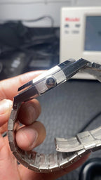 Audemars Piguet watch side profile with metal bracelet links and crown-side details.