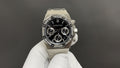 Audemars Piguet stainless steel chronograph watch with black dial and three subdials, bracelet strap