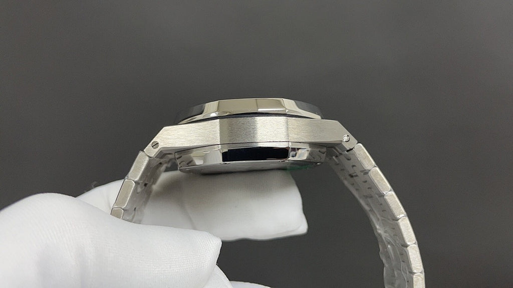 Audemars Piguet stainless steel watch case with crown, angled close-up