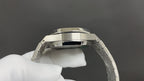 Audemars Piguet stainless steel watch case with crown, angled close-up