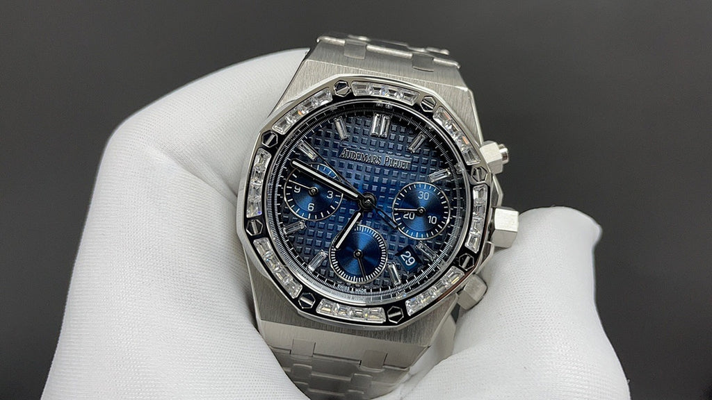 Stainless steel wristwatch with blue chronograph dial, metal bracelet, on glove