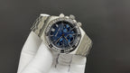 Stainless steel wristwatch angled view, blue dial with chronograph subdials