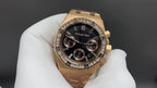 Gold Royal Oak wristwatch with black dial, diamond-set bezel, and subdials