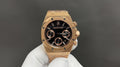 Audemars Piguet gold-tone wristwatch with black dial and three subdials