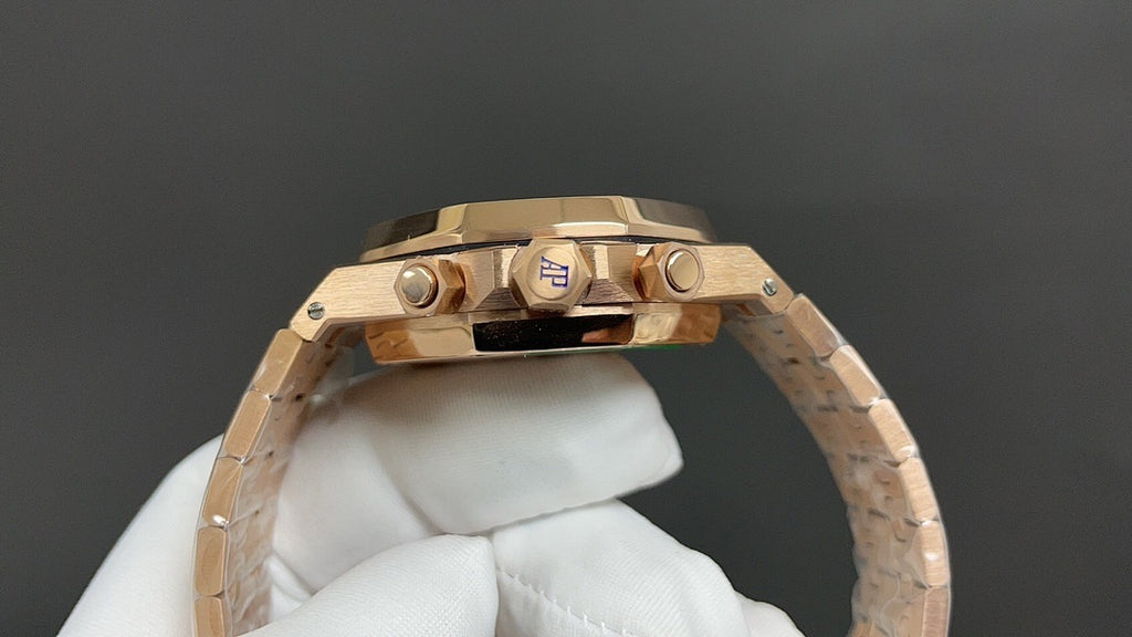 Gold-tone wristwatch top view with crown and pushers on the bezel