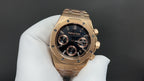 Audemars Piguet gold-tone wristwatch with black dial, baton markers, subdials