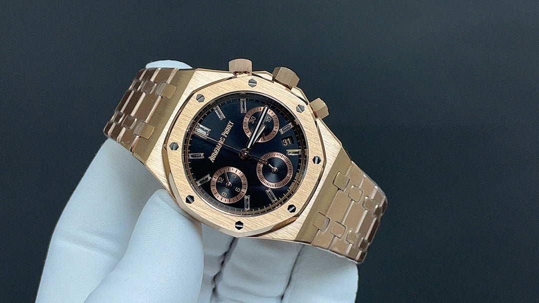 Gold-tone wristwatch with dark blue dial, three subdials, metal bracelet