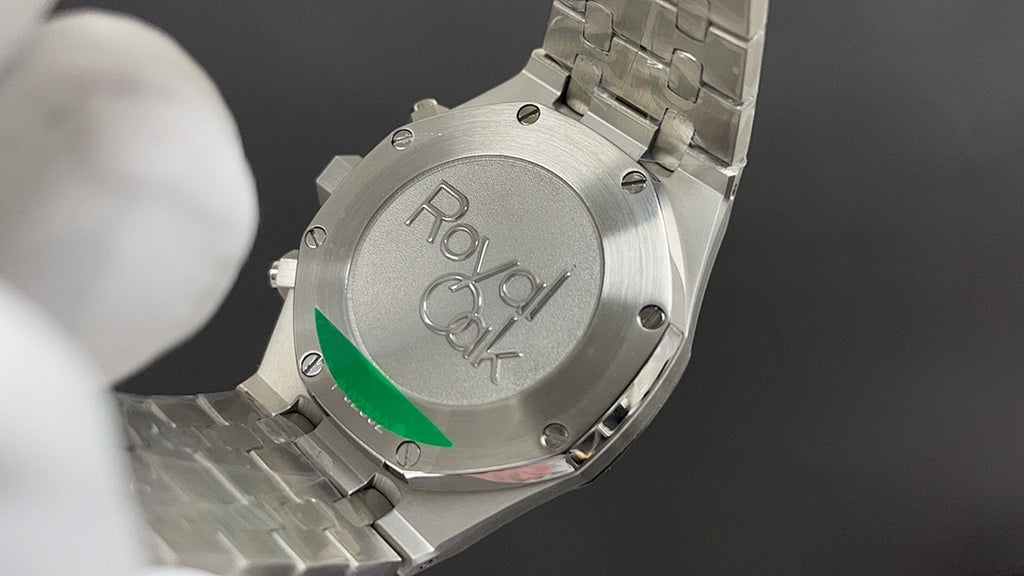 Audemars Piguet watch back case with engraved CK logo, metal bracelet.