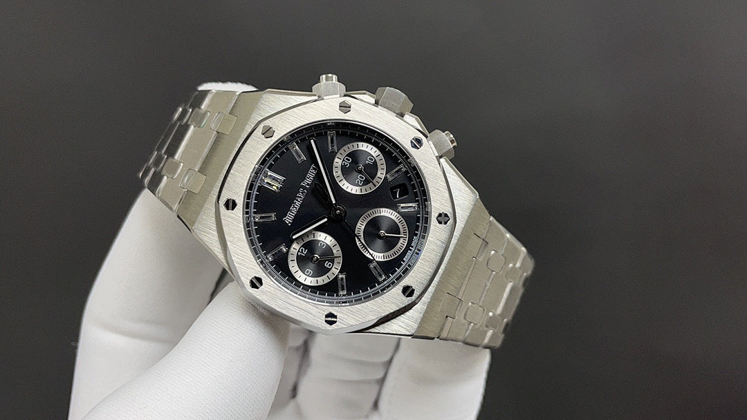 Audemars Piguet watch angled view with black dial, bezel screws, metal bracelet band.