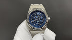 Audemars Piguet watch with blue dial and stainless steel bracelet, shown on glove.