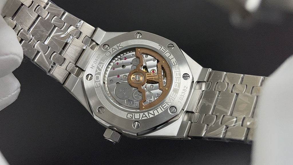 Audemars Piguet watch caseback with visible movement and stainless bracelet links.