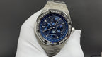 Audemars Piguet watch close-up of blue chronograph dial on stainless bracelet.