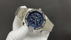 Audemars Piguet watch three-quarter view with blue dial and silver steel bracelet.