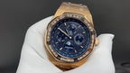Gold-tone Audemars Piguet chronograph watch with blue dial, bezel, and gold bracelet