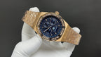 Gold-tone Audemars Piguet chronograph watch angled view with blue dial and bezel