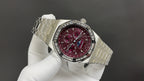 Stainless steel wristwatch with burgundy dial and metal bracelet, three-quarter view