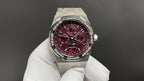 Stainless steel wristwatch with burgundy dial and metal bracelet, front view
