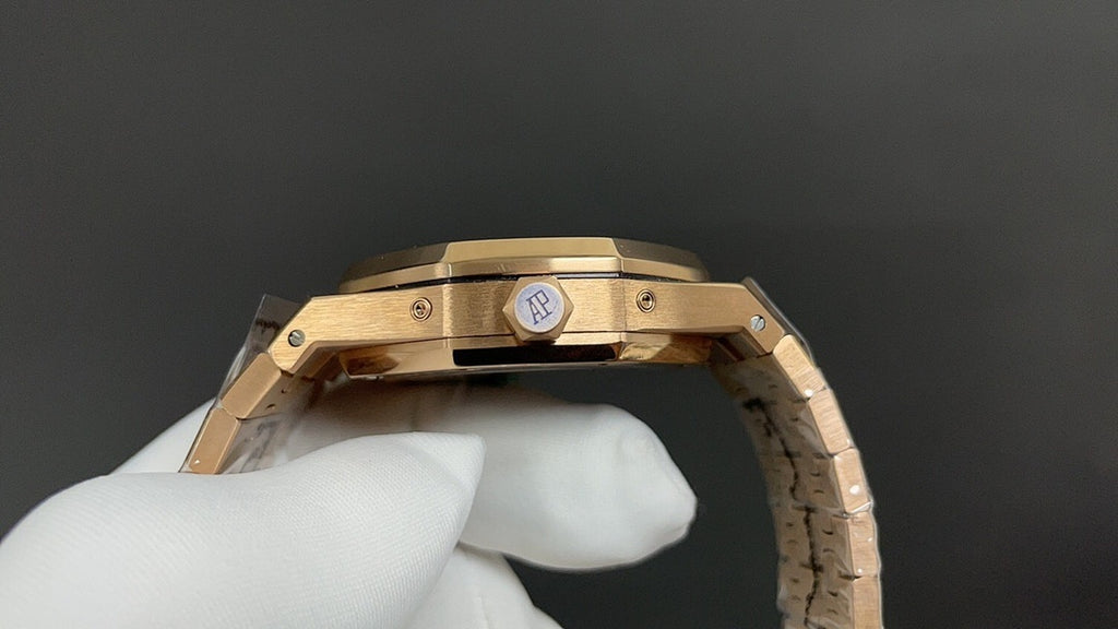 Gold-tone Audemars Piguet watch clasp with round logo plate