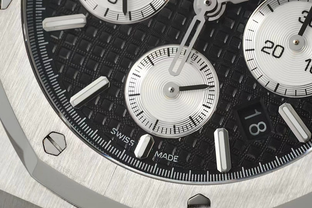 Audemars Piguet watch dial detail with black face, silver markers, and subdial