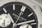 Audemars Piguet watch face close-up with black dial and Arabic subdial hands