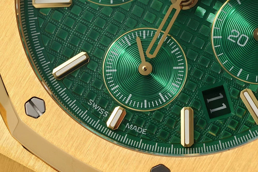 Green dial detail with subdial and gold indices reading Swiss Made
