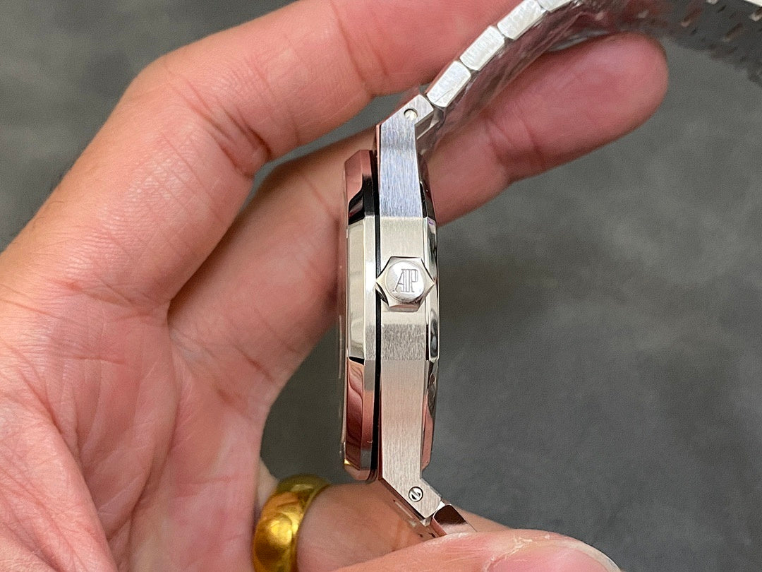 Stainless steel watch case side with crown and engraved AP emblem