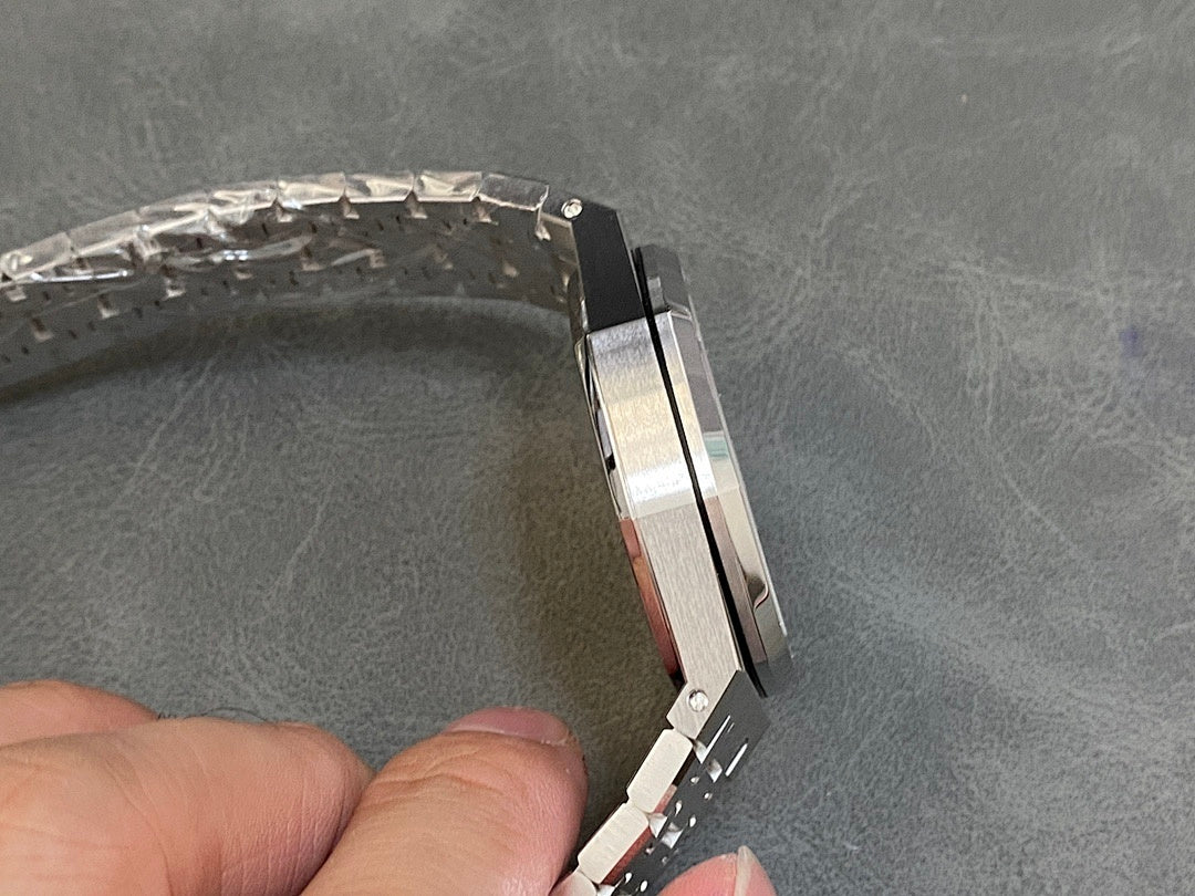Stainless steel watch case edge and bracelet links from a side angle