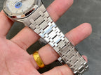 Stainless steel bracelet and watch case close-up with white dial and logo