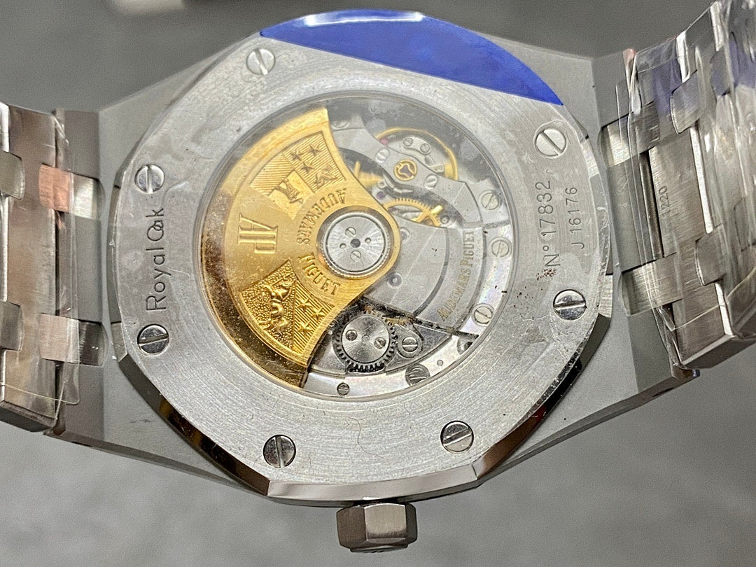 Audemars Piguet watch caseback with gold-toned disc and transparent movement window