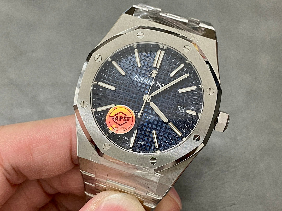 Audemars Piguet steel watch with blue dial and red AP emblem, date window at 3