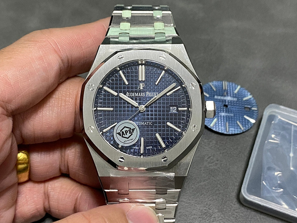 Audemars Piguet steel watch with blue dial, baton markers, date window at 3