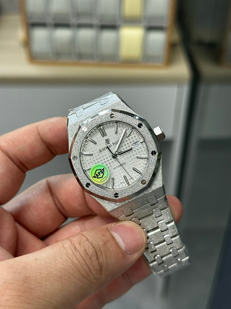 Stainless steel watch with white dial and silver hands, crown at 3 o'clock