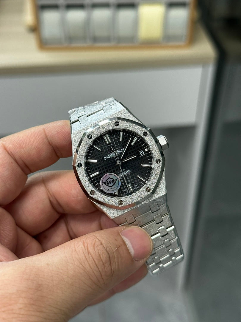 Audemars Piguet steel watch with black dial and textured bezel, side angle.