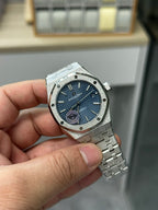 Audemars Piguet stainless steel wristwatch front view with blue dial and metal bracelet
