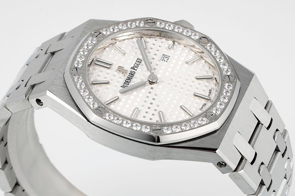 Audemars Piguet wristwatch with diamond bezel, white dial, and silver metal bracelet