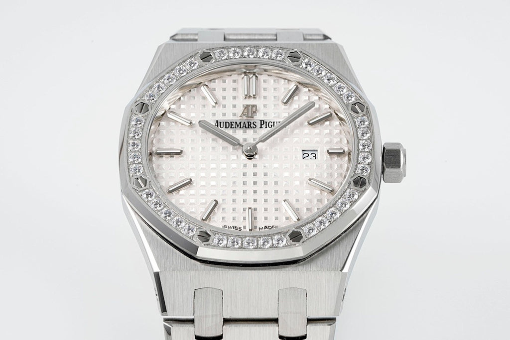 Audemars Piguet wristwatch with diamond bezel, white dial, and date shown at 23