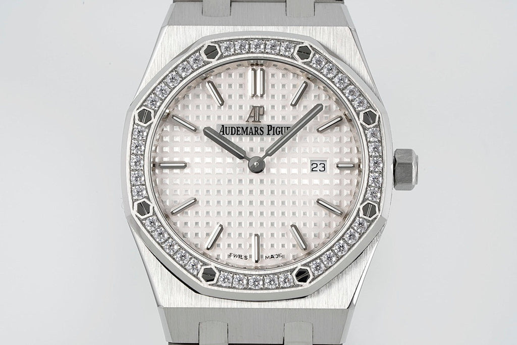 Audemars Piguet wristwatch with diamond bezel, white dial, AP logo, and date at 23