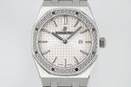 Audemars Piguet wristwatch with diamond bezel, white dial, AP logo, and date at 23